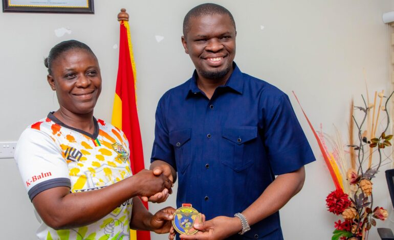 Grace Minta presenting Gold Medal to Sports Minister